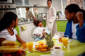 Afro American family in kitchen breakfast