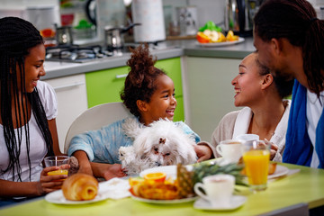 Family breakfast. Parents with their daughter's breakfast at home