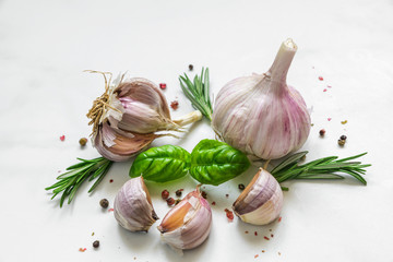 garlic, basil, rosemary and peppercorn on white marble background. close up © samael334