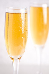 Glasses of Champagne on a Silver Glitter Backdrop