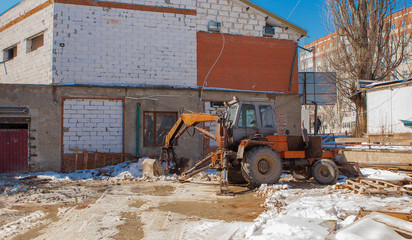 tractor for snow removal is parked on a city street after work