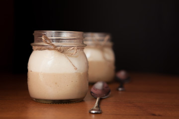 Delicious Dessert in a glass jar on a black background