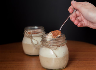 woman's hand taking delicious dessert by spoon