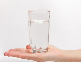 Woman hand with glass of water isolated on white background