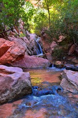 Kanarraville Falls, views from along the hiking trail of falls, stream, river, sandstone cliff formations Waterfall in Kanarra Creek Canyon by Zion National Park, Utah, USA.