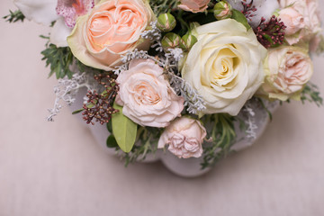 floral bouquet in a white pumpkin on a light background, a mixture of flowers, peony rose, eucalyptus, chrysanthemum, Brassica, white orchid, cotton