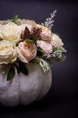 flower bouquet in a white pumpkin on a black background, a mixture of flowers, peony rose, eucalyptus, chrysanthemum, Brassica, white orchid, cotton