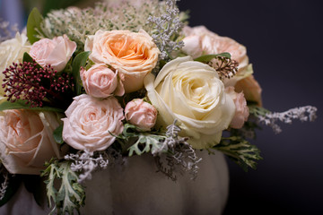 flower bouquet in a white pumpkin on a black background, a mixture of flowers, peony rose, eucalyptus, chrysanthemum, Brassica, white orchid, cotton