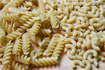 Uncooked piles of pasta on board