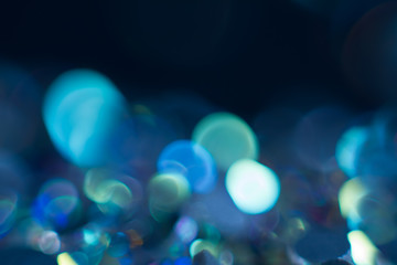 Abstraction colorful bokeh on a dark background. Defocused.