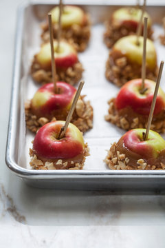 Homemade caramel dipped apples with peanuts on a tray