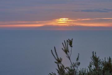 Obraz na płótnie Canvas Evening strolls on the hill sun orange and sea view