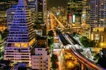 Fototapeta premium Cityscape Bangkok downtown at night, from the top of tower, Panorama view. and technique long exprosure and HDR filter. wealth of life concept. many lighting in the city.