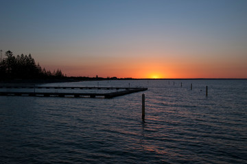 Busselton Australia, Sunset over Geographe Bay with ocean bathes in foreground