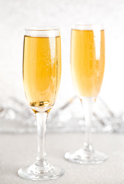 Glasses of Champagne on a Silver Glitter Backdrop