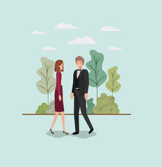 elegant business couple walking in the park