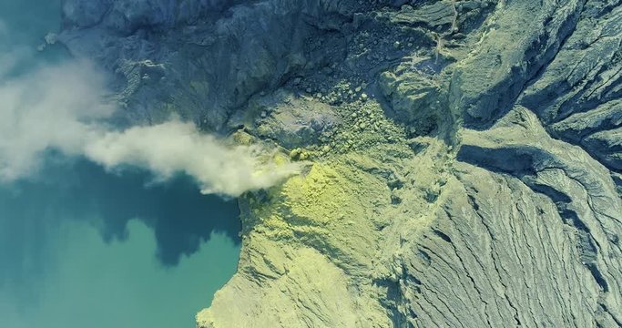 Aerial view of crater Ijen volcano with acidic lake Kawah where sulfur is mined. 4K