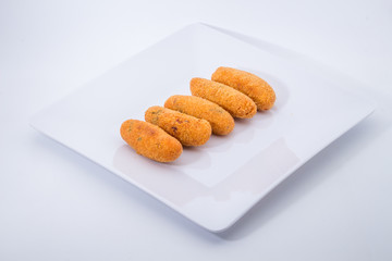 codfish fritters or codfish cakes, a traditional appetizer in Portugal on white background