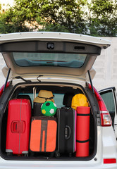 Closeup of right rear side of white car carry luggage, suitcases and things for lovely family...