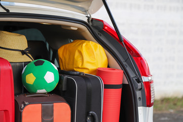 Closeup of right rear side of white car carry luggage, suitcases and things for lovely family...