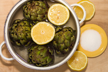 artichokes cooked with lemon and salt in the pot with water