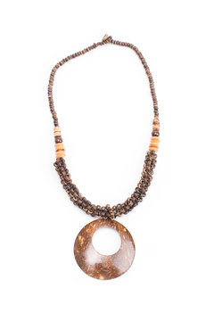 A handmade coconut shell necklace on a white background.