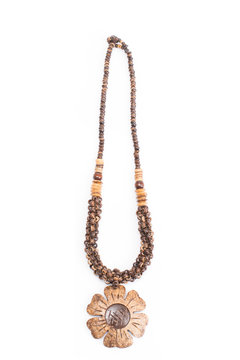 A handmade coconut shell necklace on a white background.