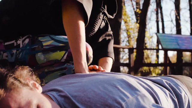 Pan shot. Close up female hands doing massage for a man