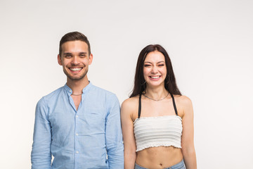 Emotions, fun and people concept - Funny couple laughing on white background