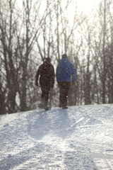 Couple walking up a snowy path