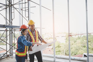 Engineers are meeting and pointing to new construction sites, Engineering tools and construction concept.