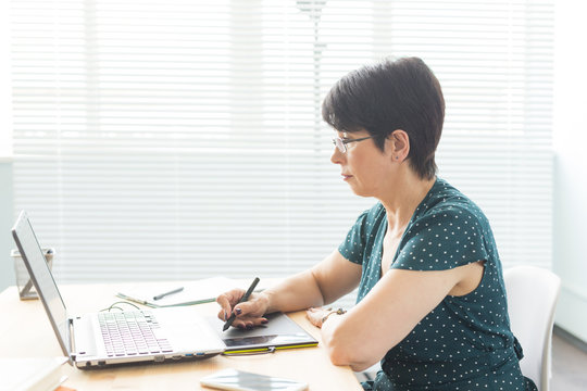 People and graphic designer concept - Middle age woman concentrated working at the office