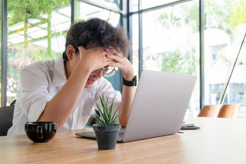 young businesswoman working with laptop documents in office and looking up, business concept