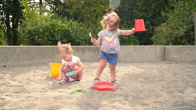 Dirty Kids Playing in Park Sand Pit