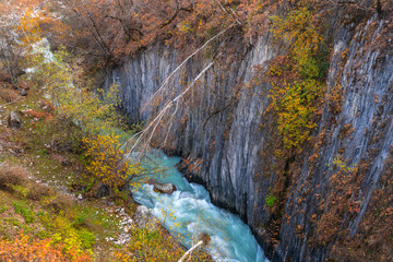 Wild river stream among cliffs and rocks, Enguri, autumn time in Mestia, Svaneti, Georgia