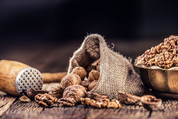 Walnut kernels whole walnuts in burlap sack and vintage bowl
