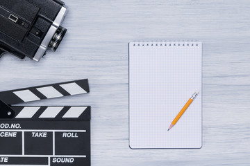 on a bright background of the director's desk are a notebook and a camera