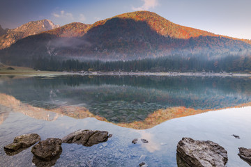 Autumnal forest reflection in Fusine Lakes,Italy