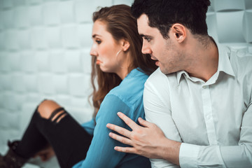 Cinematic tone of young handsome man trying to reconcile with his beautiful girlfriend after have...