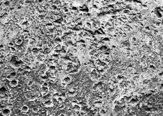 Many rugged holes on the gray concrete floor