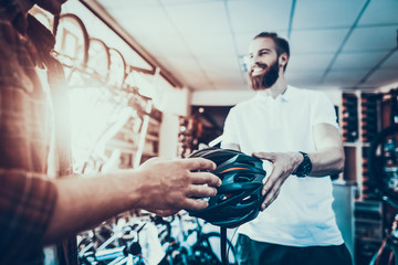 Closeup of Happy Consultant give Helmet to Buyer - Powered by Adobe