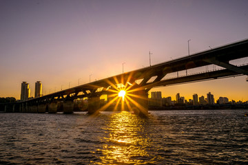 The sun goes down under Cheongdam Bridge.
