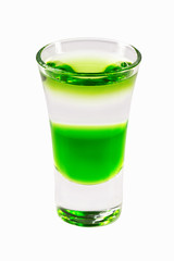 Closeup glass of green fairy layered cocktail shot with absinthe isolated at white background.