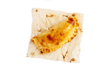 Yellow crispy khachapuri on a cooking paper isolated at white background.