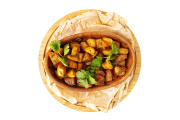 Cruze pot with stew beef and potato served on a cooking paper at wooden board isolated at white background.