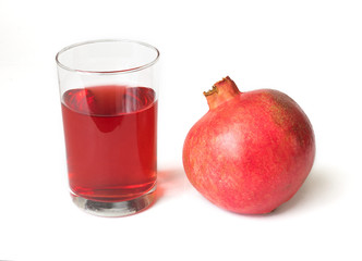 Fresh pomegranate juice in a glass cup and pomegranate isolated on white background