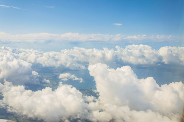 Picture of airplane wing, cloudy sky from porthole