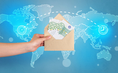 Female hand holding coloured and white envelope with blue map on the background

