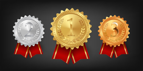 Gold, silver and bronze medals with red ribbons isolated on black background. Vector design element.