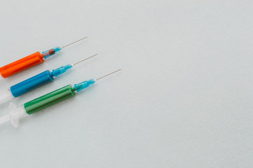 Three syringes on a light background. Cancer Cure Concept